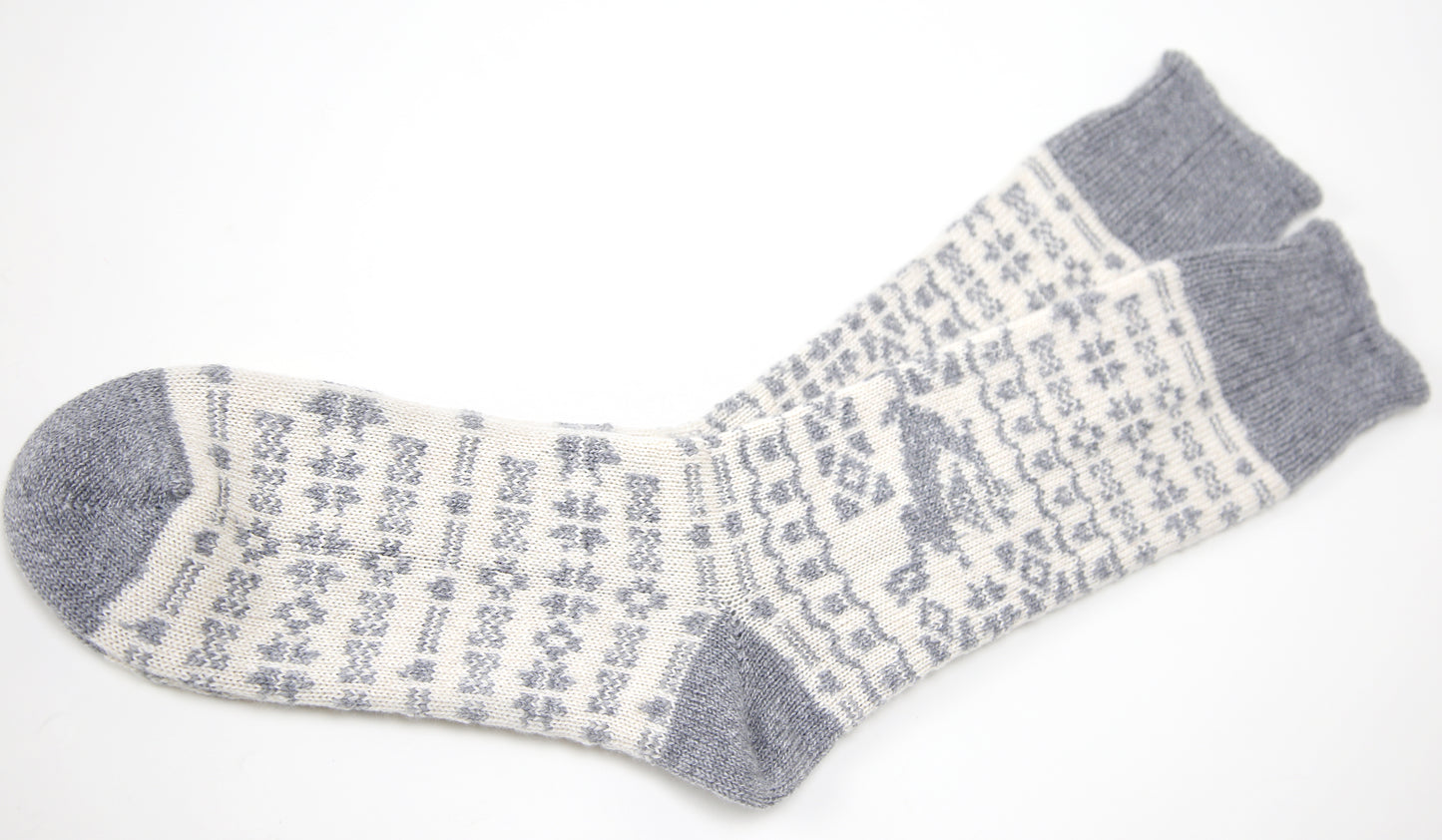 Grey and ecru cream calf length cashmere socks made in the UK. Designed with snowflakes and a leaping deer these cashmere socks are luxury loungewear for women and men