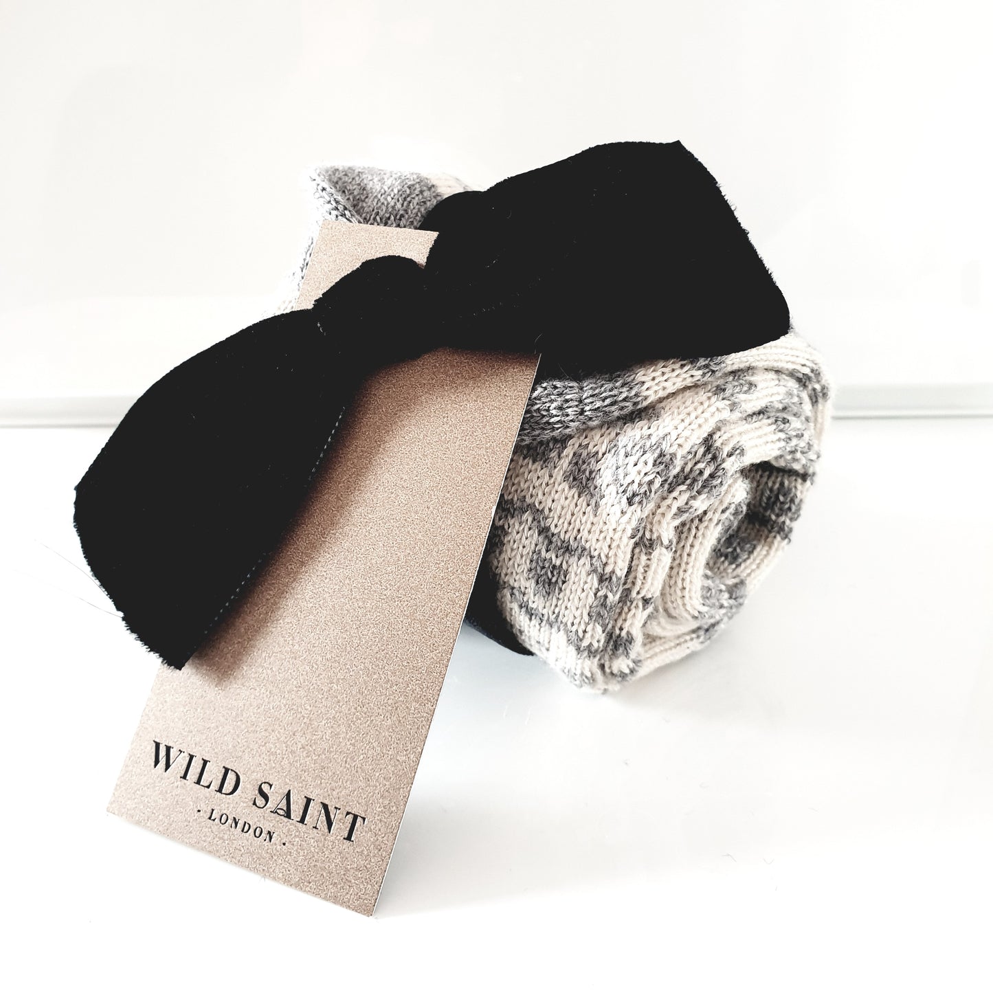 Grey and ecru cream calf length cashmere socks made in the UK. Designed with snowflakes and a leaping deer these cashmere socks are luxury loungewear for women and men
