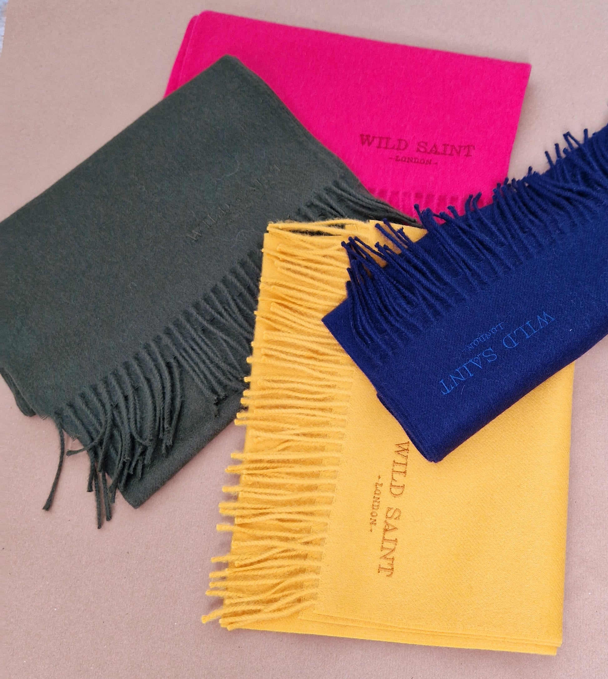 Collecton of colourful scarves Sunflower Yellow, moss green, navy and hot pink. Medium weight 100% baby alpaca scarf for women and men. Gift wrapped as standard and includes complimentary personlisation. Sustainable Luxury designer scarf